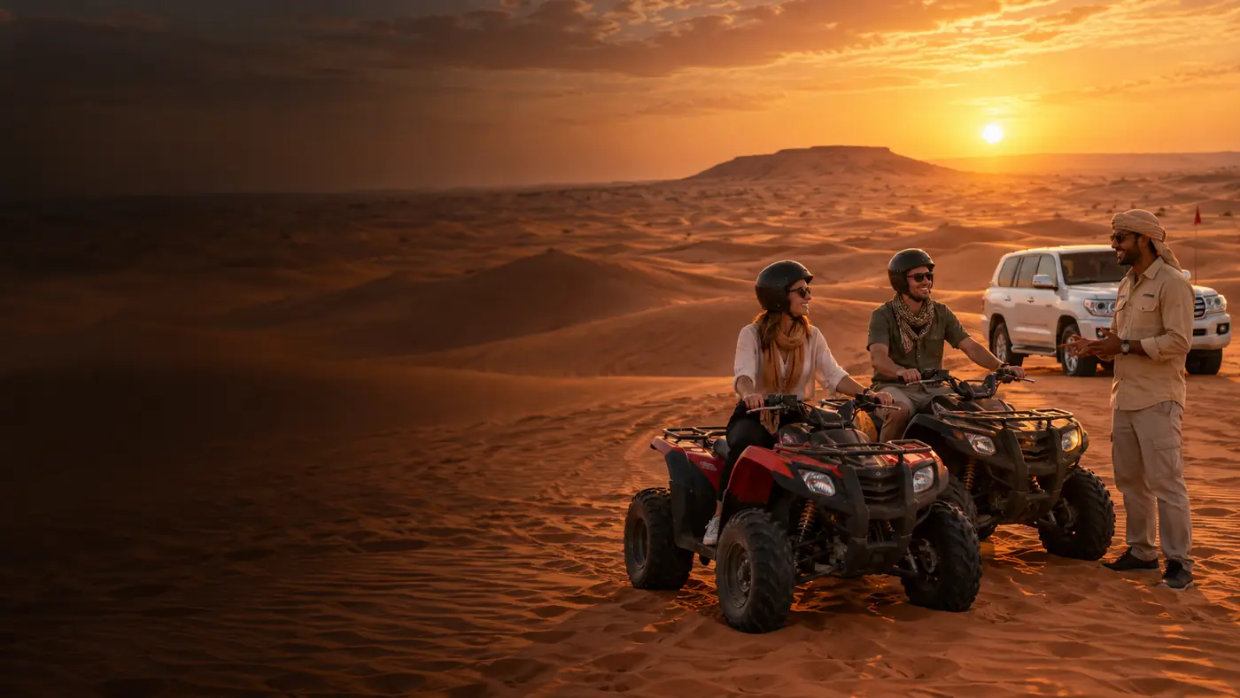 Helmeted couple receiving instructions beside quad bikes in the Dubai desert at sunset