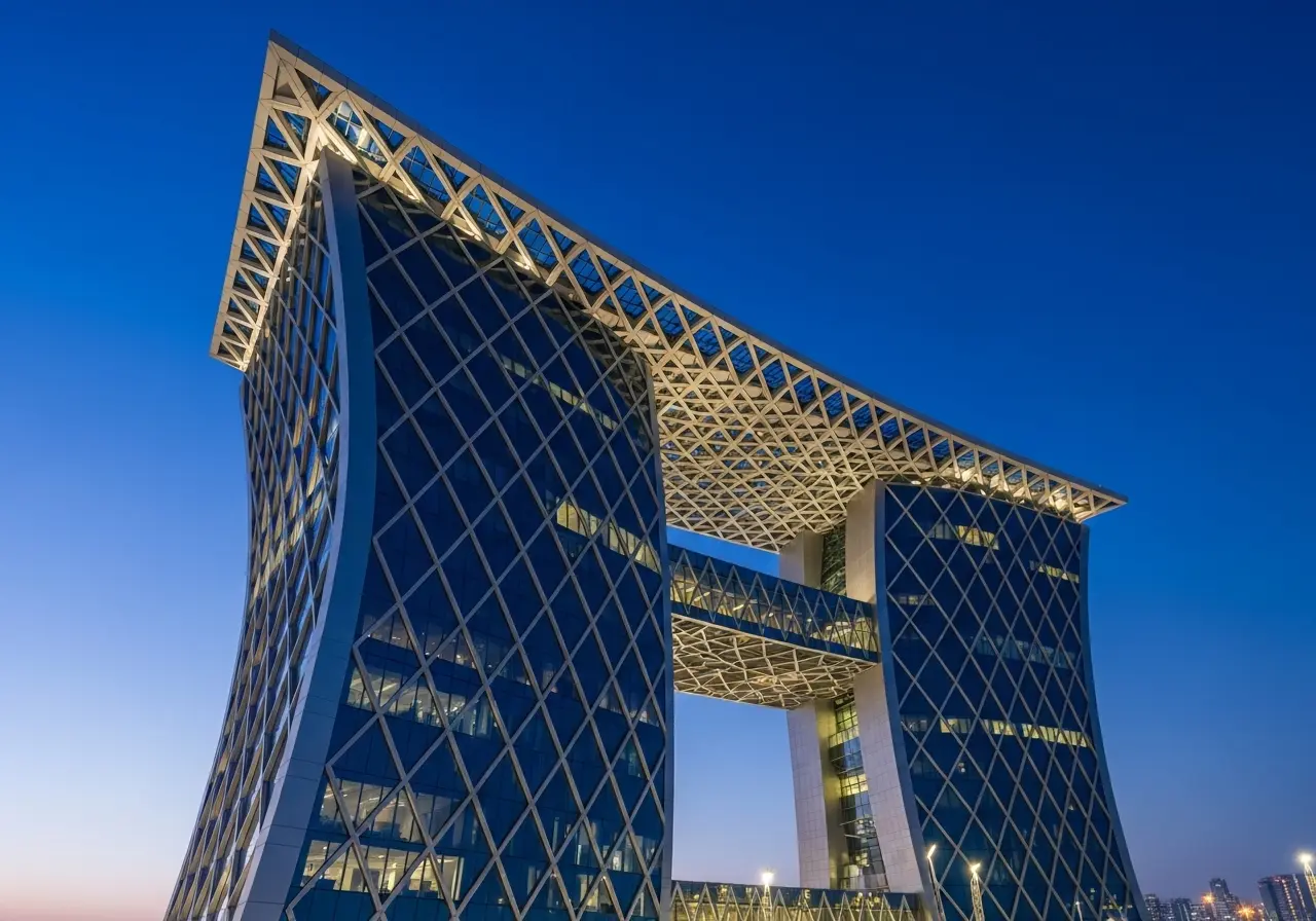 The iconic, leaning Abu Dhabi Capital Gate illuminated at night during a tour.